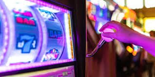 Mobile phone showing pgsoft games deposit screen with payment method icons for DANA, OVO, GoPay, QRIS, and bank transfers